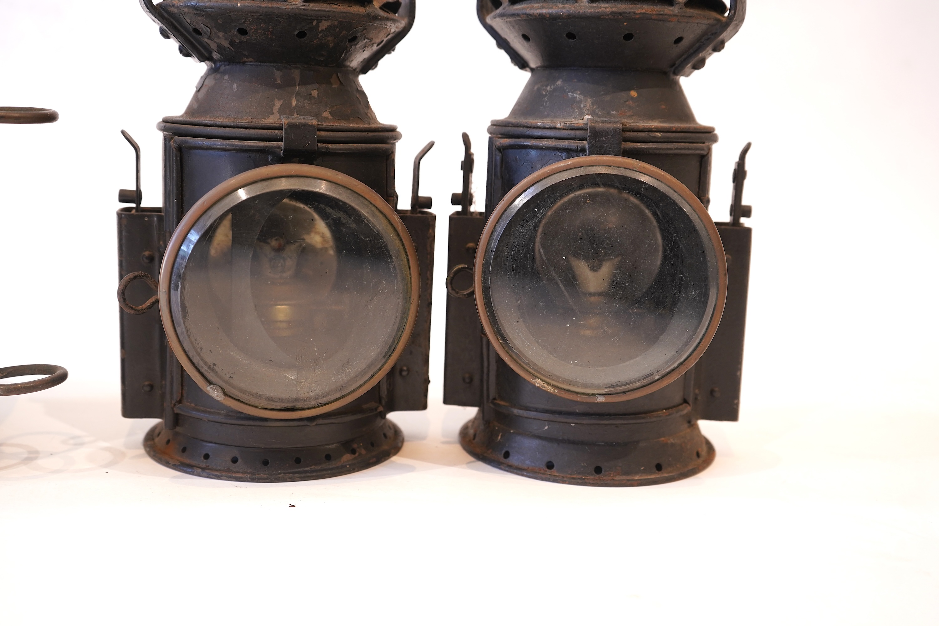 Two black painted railway hand lamps by Pratt & Co. Ltd. Birmingham, both dated 1945, both with burners and reflections, one intended for three colour aspect, with one glass missing, together with a brass ship’s bulkhead